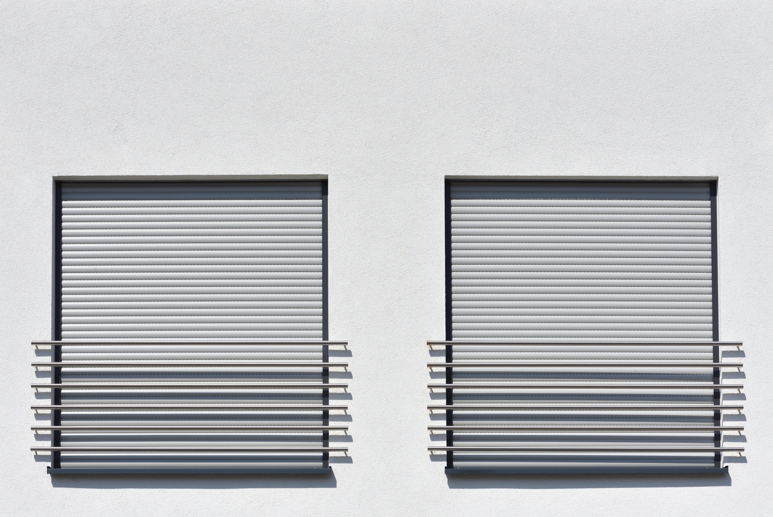 close up window roller shutters white wall scaled